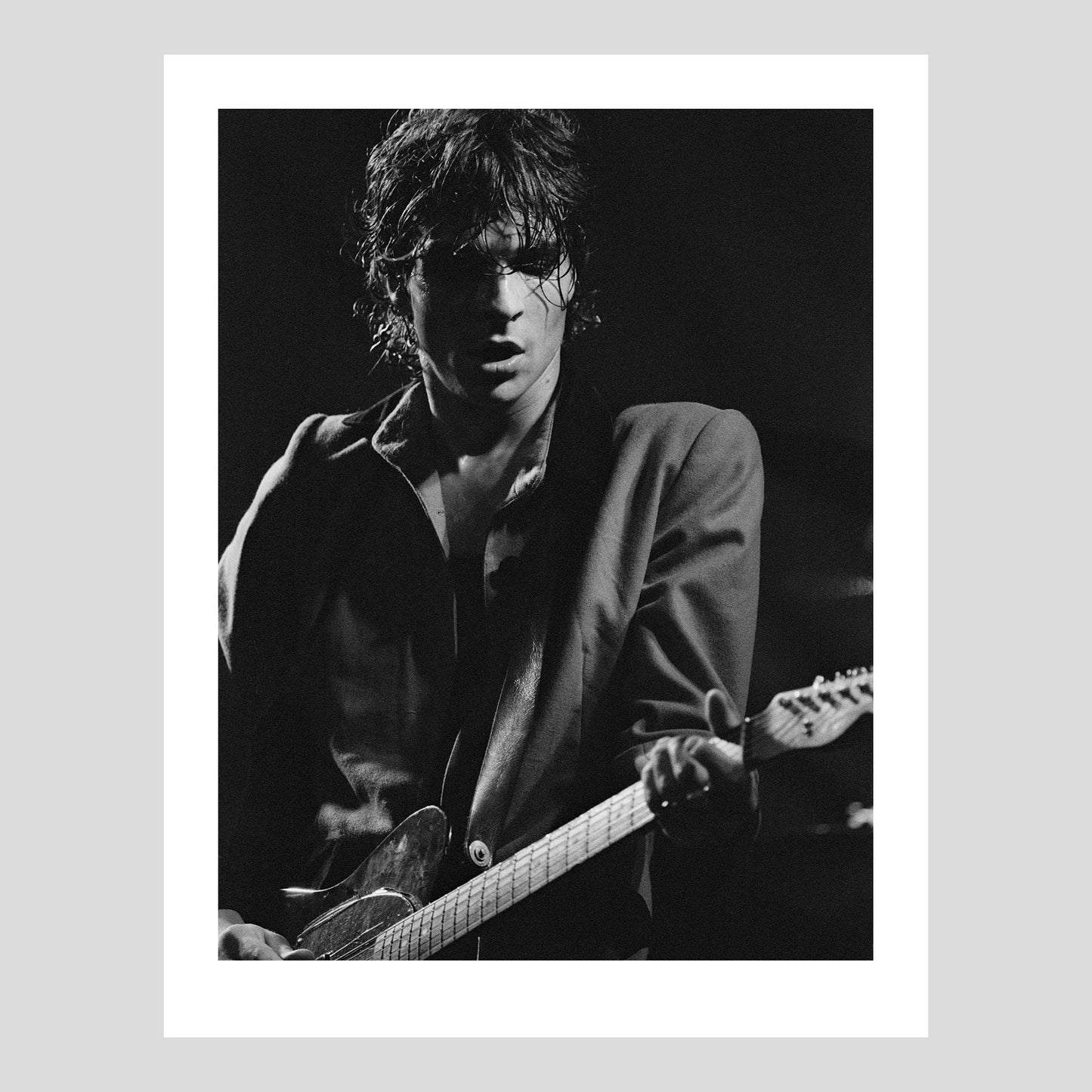 Joakim Thåström on stage with Imperiet at Moderna Museets Trädgård, Jul 25, 1984. Photograph by Johan Ödmann. Rock Lumiere Editions offer beautiful Rock Photography Posters and Limited Edition Fine Art Prints. Choose among unique b/w photographs of legendary artists and bands. Order your favorite music photography today. Worldwide shipping.