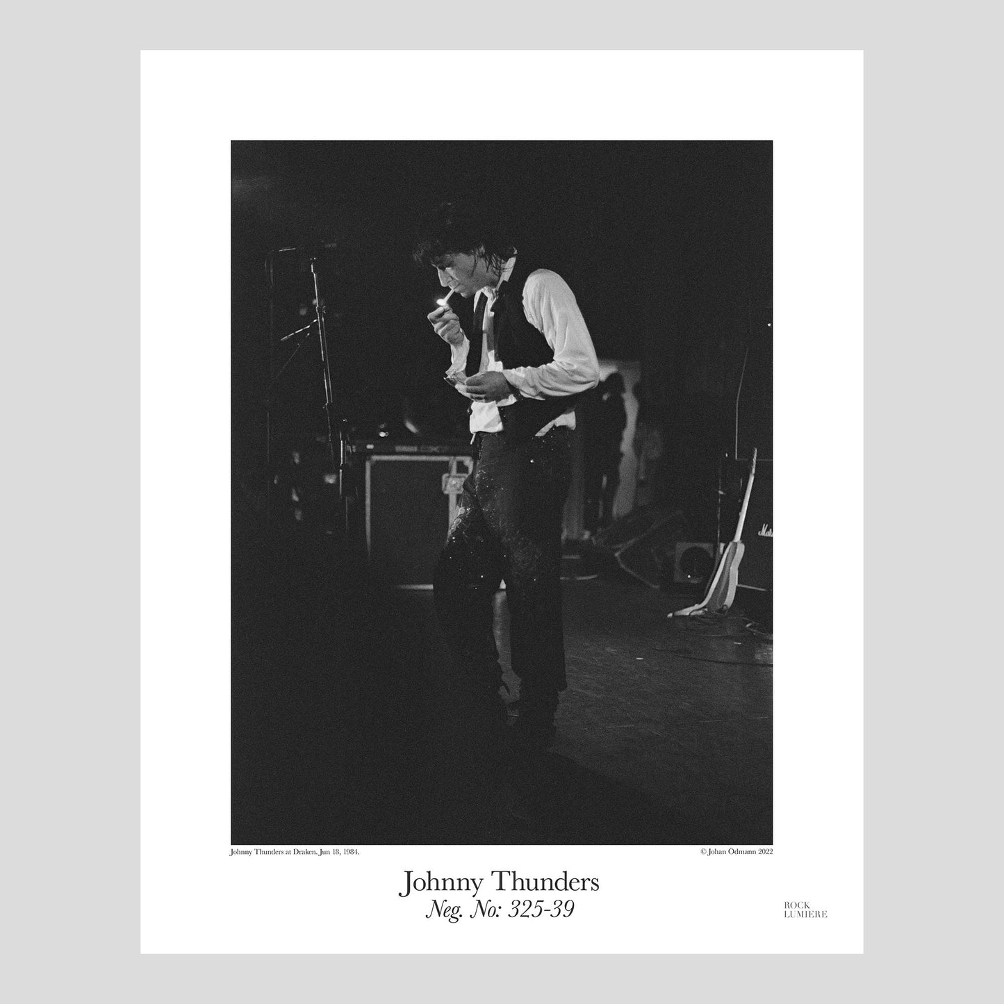 Johnny Thunders lighting a cigarette on stage. The Revenge Tour at Draken, Sweden, Jun 18, 1984. Photography by Johan Ödmann. Rock Lumiere Editions offer beautiful Rock Photography Posters and Limited Edition Fine Art Prints. Choose among unique b/w photographs of legendary artists and bands. Order today. Worldwide shipping.