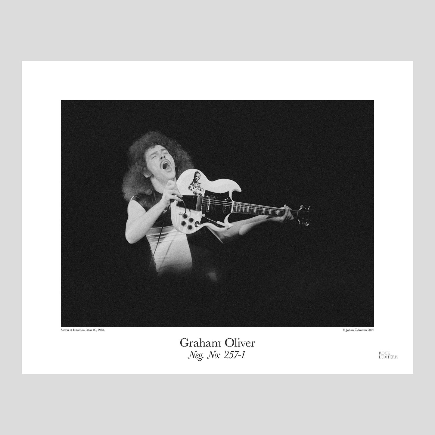 Graham Oliver with his iconic white SG on stage with Saxon at Isstadion, Mar 09, 1984. Photograph by Johan Ödmann. Rock Lumiere Editions offer beautiful Rock Photography Posters and Limited Edition Fine Art Prints.  Choose among unique b/w photographs of legendary artists and bands.  Order today. Worldwide shipping.