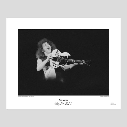 Graham Oliver with his iconic white SG on stage with Saxon at Isstadion, Mar 09, 1984. Photograph by Johan Ödmann. Rock Lumiere Editions offer beautiful Rock Photography Posters and Limited Edition Fine Art Prints.  Choose among unique b/w photographs of legendary artists and bands.  Order today. Worldwide shipping.